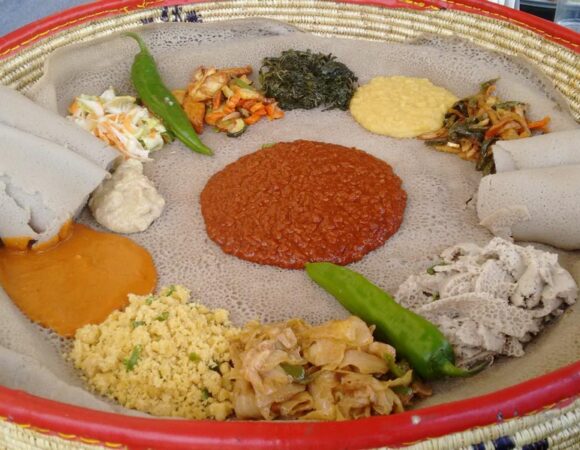 Authentic Ethiopian culinary feast served on injera sourdough flatbread with seasoned stews