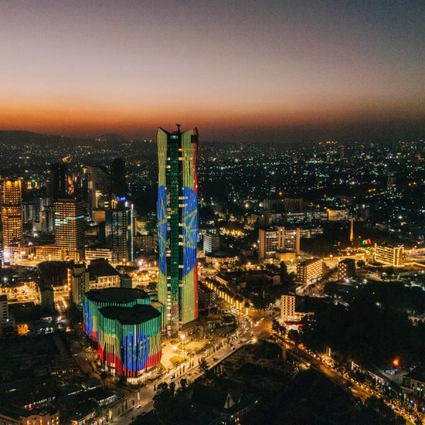 Addis Ababa skyline at night with buildings lit in the colours of the Ethiopian flag